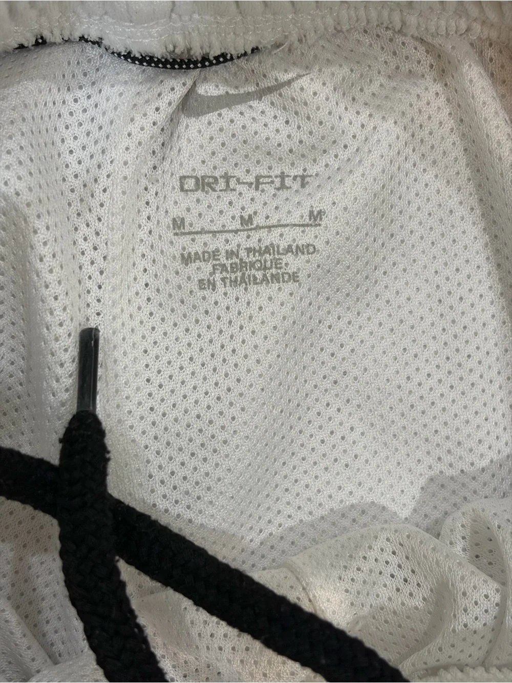 Nike Dri-Fit white basketball shorts with black stripes on sides, Youth size M